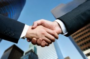 Handshake in front of tall buildings