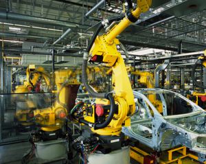 Car on assembly line with robot arms working