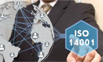 Businessman holding a transparent globe pointing at ISO 14001