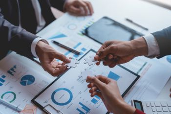 Group of businesspeople holding jigsaw puzzles, team solving and planning together Group of businesspeople holding jigsaw puzzles, team solving and planning together