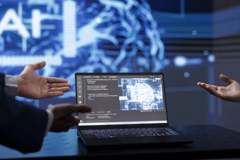 Close up of IT specialists using artificial intelligence technology on notebook