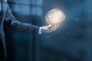 A person holding a brain in their hand, meant to symbolize artificial intelligence.